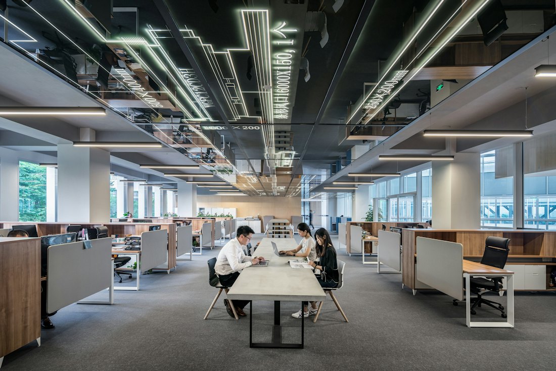 An open-plan office floor, mostly empty desks